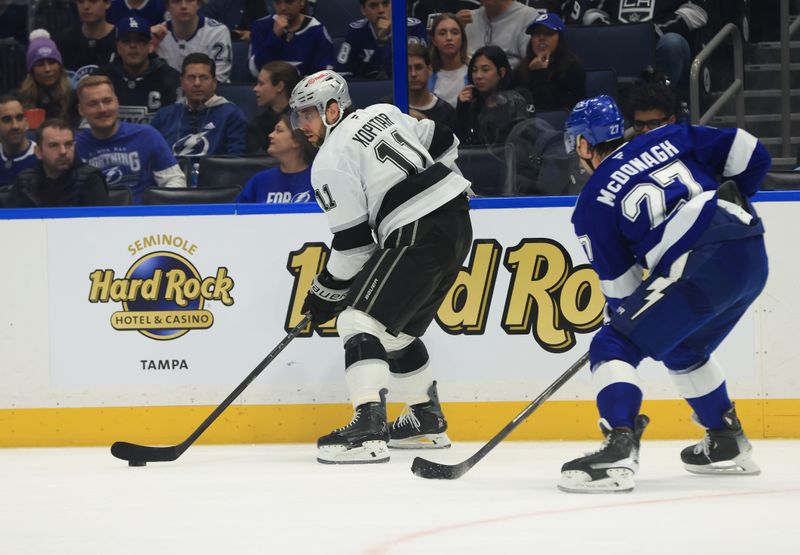 Dec 18, 2025; Tampa, Florida, USA; Los Angeles Kings center Anze Kopitar (11) skates with the puck as Tampa Bay Lightning defenseman Ryan McDonagh (27) defends during the second period at Benchmark International Arena. Mandatory Credit: Kim Klement Neitzel-Imagn Images