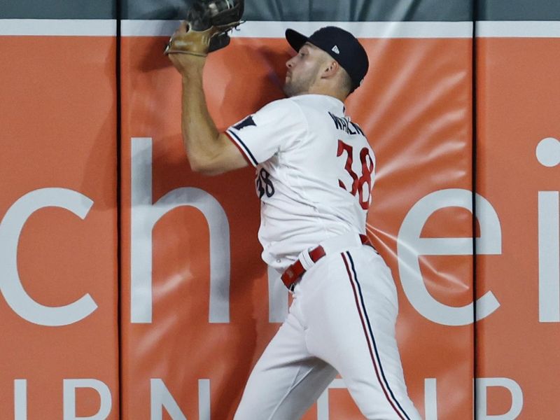 Aug 25, 2023; Minneapolis, Minnesota, USA; Minnesota Twins left fielder Matt Wallner (38) hits the wall after catching a long fly ball by Texas Rangers shortstop Corey Seager (not pictured) in the sixth inning at Target Field. Mandatory Credit: Bruce Kluckhohn-USA TODAY Sports