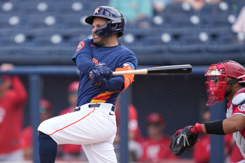 Mar 2, 2026; West Palm Beach, Florida, USA;  Houston Astros left fielder Jose Altuve (27) hits a single in the first inning against the Washington Nationals at CACTI Park of the Palm Beaches. Mandatory Credit: Jim Rassol-Imagn Images