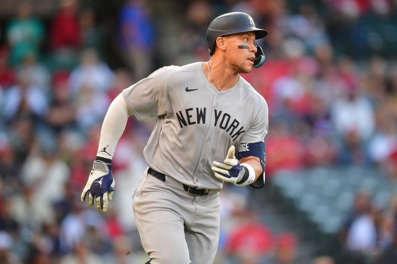 May 27, 2025; Anaheim, California, USA; New York Yankees right fielder Aaron Judge (99) runs after hitting a single against the Los Angeles Angels during the first inning at Angel Stadium. Mandatory Credit: Gary A. Vasquez-Imagn Images
