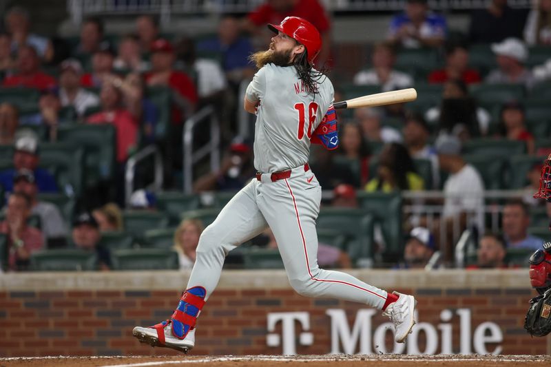 Aug 21, 2024; Atlanta, Georgia, USA; Philadelphia Phillies left fielder Brandon Marsh (16) drives in a run on a sacrifice fly against the Atlanta Braves in the eighth inning at Truist Park. Mandatory Credit: Brett Davis-USA TODAY Sports