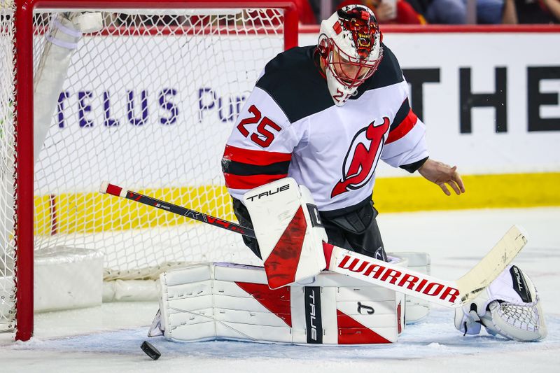 Jan 19, 2026; Calgary, Alberta, CAN; New Jersey Devils goaltender Jacob Markstrom (25) makes a save against the Calgary Flames during the second period at Scotiabank Saddledome. Mandatory Credit: Sergei Belski-Imagn Images