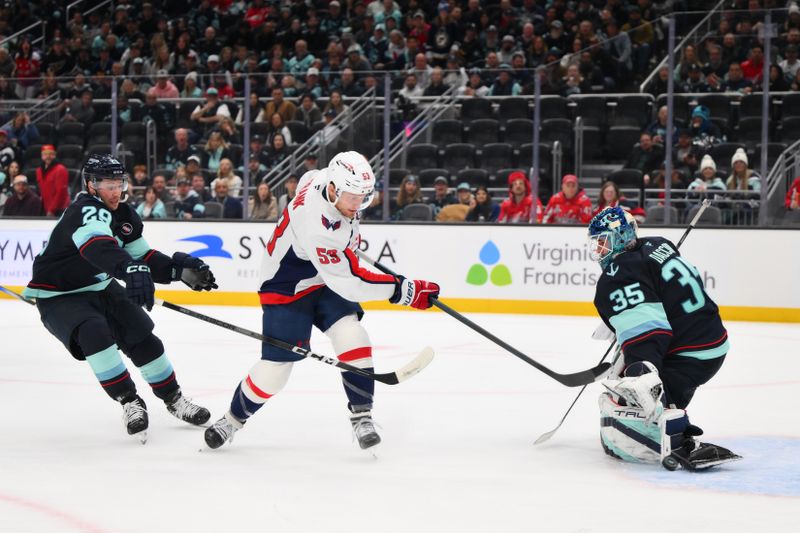 Jan 23, 2025; Seattle, Washington, USA; Washington Capitals center Ethen Frank (53) scores a goal past Seattle Kraken goaltender Joey Daccord (35) during the second period at Climate Pledge Arena. Mandatory Credit: Steven Bisig-Imagn Images