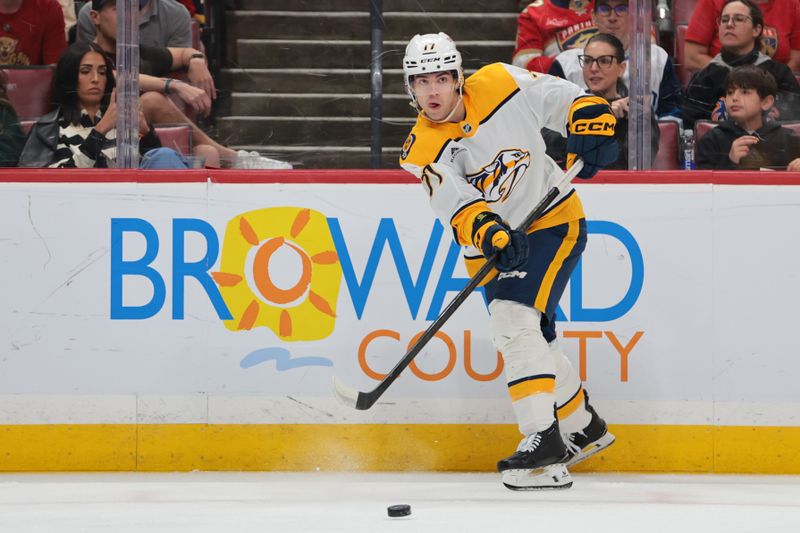 Dec 4, 2025; Sunrise, Florida, USA; Nashville Predators center Tyson Jost (17) passes the puck against the Florida Panthers during the first period at Amerant Bank Arena. Mandatory Credit: Sam Navarro-Imagn Images