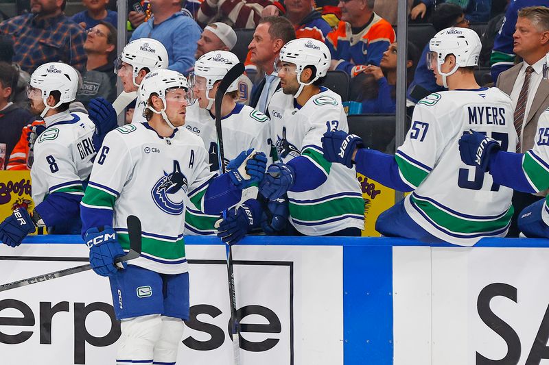 Oct 11, 2025; Edmonton, Alberta, CAN;  The Vancouver Canucks celebrate a goal by forward Brock Boeser (6) during the third period against the Edmonton Oilersat Rogers Place. Mandatory Credit: Perry Nelson-Imagn Images