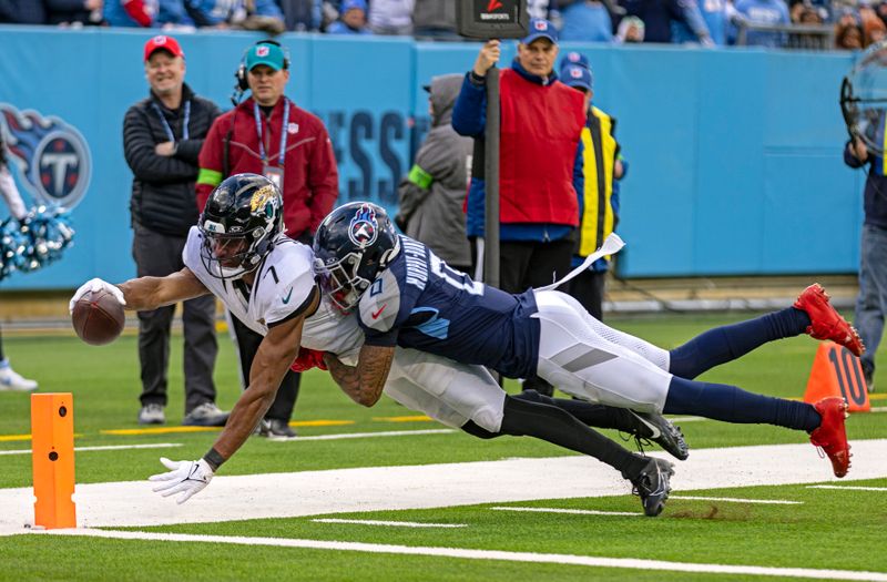 Jacksonville Jaguars wide receiver Zay Jones (7) dives for the goal line as he's tackled by Tennessee Titans cornerback Sean Murphy-Bunting (0) during their NFL football game Sunday, Jan. 7, 2024, in Nashville, Tenn. (AP Photo/Wade Payne)