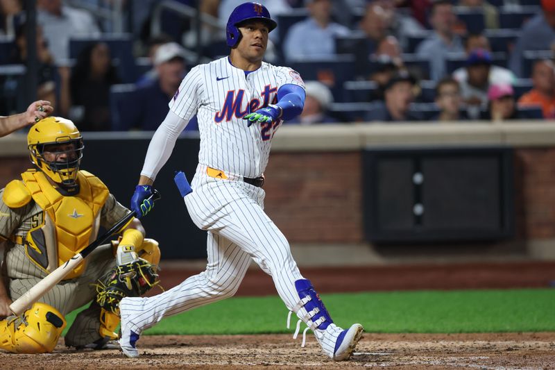 Sep 17, 2025; New York City, New York, USA; New York Mets right fielder Juan Soto (22) hits a home run during the fifth inning against the San Diego Padres at Citi Field. Mandatory Credit: Vincent Carchietta-Imagn Images