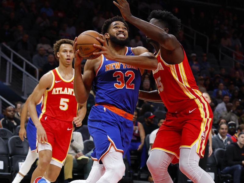 ATLANTA, GEORGIA - NOVEMBER 6: Karl-Anthony Towns #32 of the New York Knicks drives to the basket against Clint Capela #15 of the Atlanta Hawks during the first quarter at State Farm Arena on November 6, 2024 in Atlanta, Georgia. NOTE TO USER: User expressly acknowledges and agrees that, by downloading and or using this photograph, User is consenting to the terms and conditions of the Getty Images License Agreement. (Photo by Todd Kirkland/Getty Images)