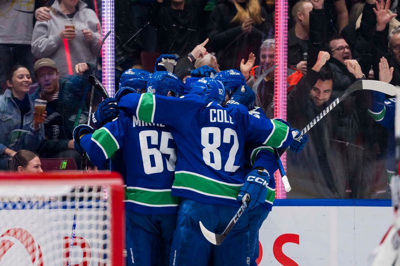 Dec 9, 2023; Vancouver, British Columbia, CAN; Vancouver Canucks forward Elias Pettersson (40) and forward Sam Lafferty (18) and defenseman Noah Juulsen (47) and forward Ilya Mikheyev (65) and defenseman Ian Cole (82) celebrate Lafferty   s goal against the Carolina Hurricanes in the first period at Rogers Arena. Mandatory Credit: Bob Frid-USA TODAY Sports