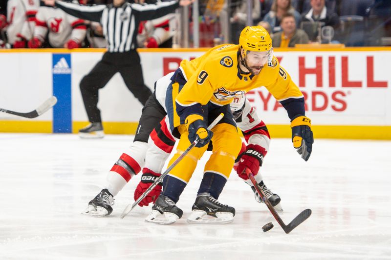 Feb 13, 2024; Nashville, Tennessee, USA;  Nashville Predators left wing Filip Forsberg (9) skates as New Jersey Devils defenseman Simon Nemec (17) defends during the first period at Bridgestone Arena. Mandatory Credit: Steve Roberts-USA TODAY Sports