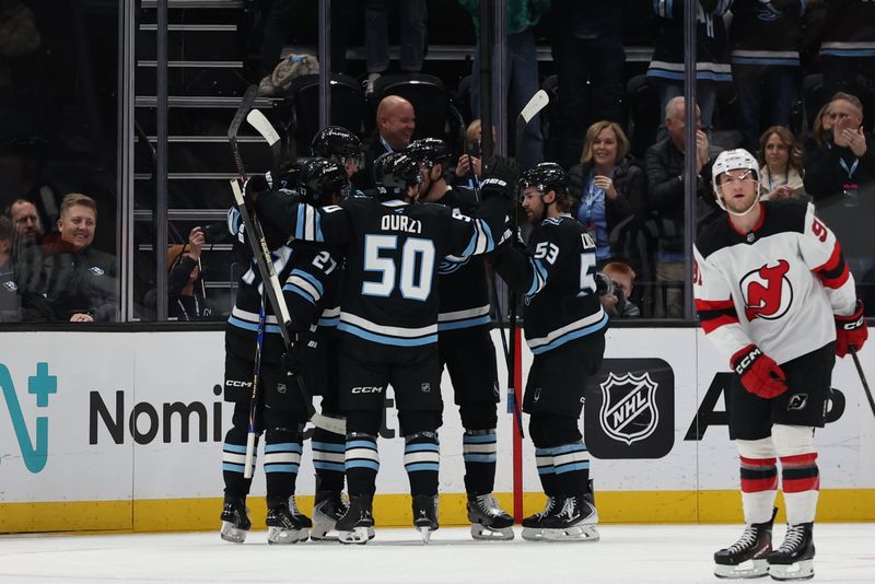 Dec 19, 2025; Salt Lake City, Utah, USA; The Utah Mammoth celebrate after a goal by left wing Daniil But (19) during the first period of the game against the New Jersey Devils at Delta Center. Mandatory Credit: Rob Gray-Imagn Images