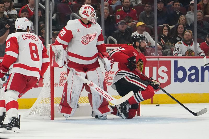 Nov 6, 2024; Chicago, Illinois, USA; Chicago Blackhawks left wing Patrick Maroon (77) goes for the puck in front on Detroit Red Wings goaltender Cam Talbot (39) during the first period at United Center. Mandatory Credit: David Banks-Imagn Images