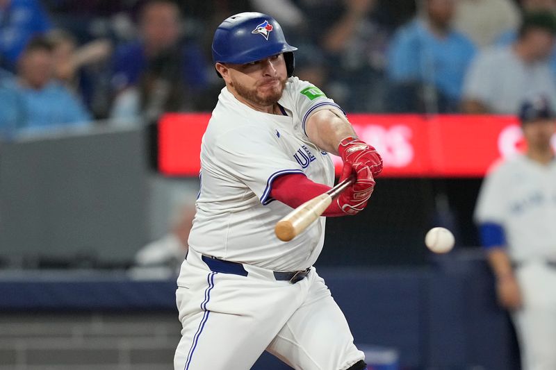 Jun 5, 2025; Toronto, Ontario, CAN; Toronto Blue Jays designated hitter Alejandro Kirk (30) hits an RBI single against the Philadelphia Phillies during the sixth inning at Rogers Centre. Mandatory Credit: John E. Sokolowski-Imagn Images