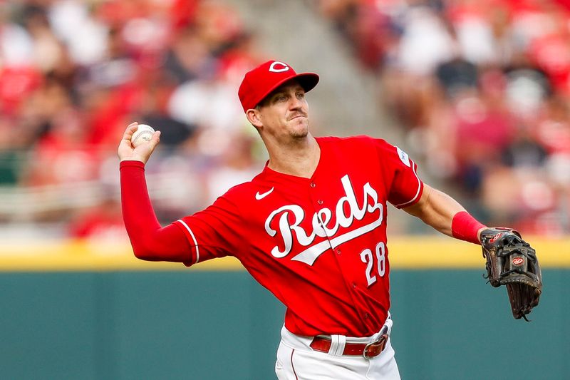 Jun 24, 2023; Cincinnati, Ohio, USA; Cincinnati Reds third baseman Kevin Newman (28) throws to first to get Atlanta Braves right fielder Ronald Acuna Jr. (not pictured) out in the sixth inning at Great American Ball Park. Mandatory Credit: Katie Stratman-USA TODAY Sports