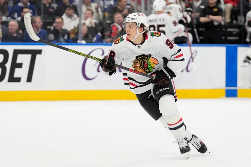 Dec 2, 2024; Toronto, Ontario, CAN; Chicago Blackhawks forward Connor Bedard (98) skates against the Toronto Maple Leafs during the second period at Scotiabank Arena. Mandatory Credit: John E. Sokolowski-Imagn Images