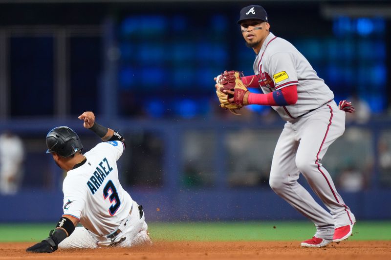 Sep 17, 2023; Miami, Florida, USA; Atlanta Braves shortstop Orlando Arcia (11) tags out Miami Marlins second baseman Luis Arraez (3) during the fifth inning at loanDepot Park. Mandatory Credit: Rich Storry-USA TODAY Sports