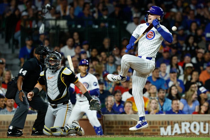 Sep 2, 2024; Chicago, Illinois, USA; Chicago Cubs outfielder Pete Crow-Armstrong (52) is hit by a pitch from Pittsburgh Pirates starting pitcher Jared Jones during the fifth inning at Wrigley Field. Mandatory Credit: Kamil Krzaczynski-USA TODAY Sports