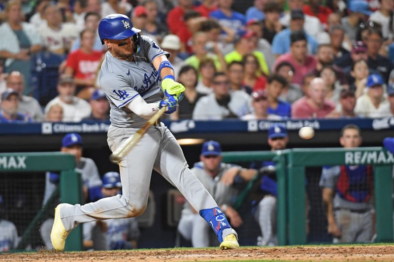 Jul 10, 2024; Philadelphia, Pennsylvania, USA; Los Angeles Dodgers shortstop Miguel Rojas (11) hits an RBI single during the eighth inning against the Philadelphia Phillies at Citizens Bank Park. Mandatory Credit: Eric Hartline-USA TODAY Sports