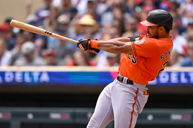 Jul 8, 2023; Minneapolis, Minnesota, USA;  Baltimore Orioles designated hitter Anthony Santander (25) hits an RBI single against the Minnesota Twins during the second inning at Target Field. Mandatory Credit: Nick Wosika-USA TODAY Sports