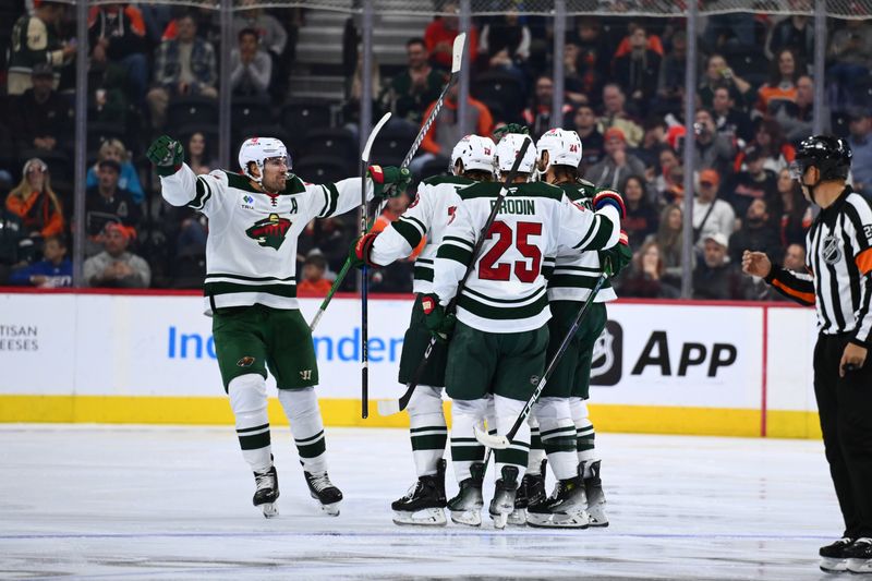 Oct 26, 2024; Philadelphia, Pennsylvania, USA; Minnesota Wild left wing Marcus Foligno (17) celebrates with teammates after scoring a goal against the Philadelphia Flyers in the third period at Wells Fargo Center. Mandatory Credit: Kyle Ross-Imagn Images