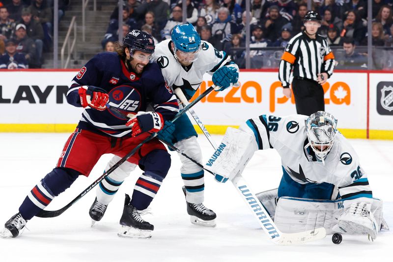 Feb 14, 2024; Winnipeg, Manitoba, CAN; Winnipeg Jets left wing Alex Iafallo (9) has a shot stopped by San Jose Sharks goaltender Kaapo Kahkonen (36) in the second period at Canada Life Centre. Mandatory Credit: James Carey Lauder-USA TODAY Sports