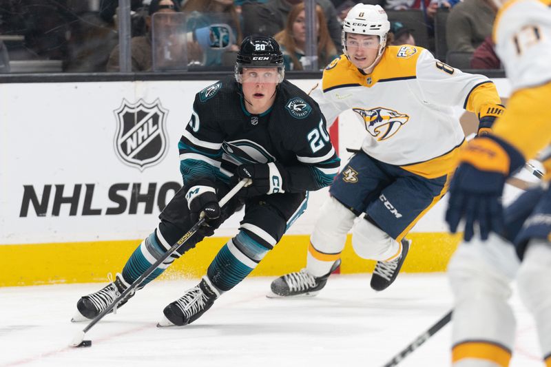 Feb 24, 2024; San Jose, California, USA; San Jose Sharks left wing Fabian Zetterlund (20) controls the puck during the first period against Nashville Predators center Cody Glass (8) at SAP Center at San Jose. Mandatory Credit: Stan Szeto-USA TODAY Sports