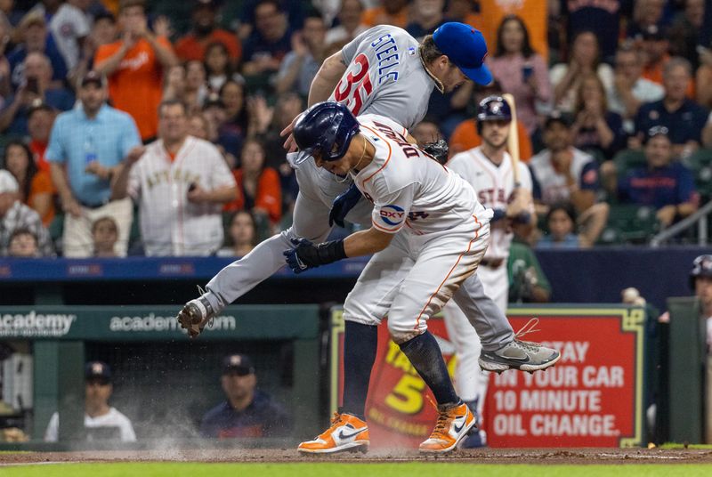 May 16, 2023; Houston, Texas, USA;  Houston Astros second baseman Mauricio Dubon (14) steals home on a wild pitch against Chicago Cubs starting pitcher Justin Steele (35) in the first inning at Minute Maid Park. Mandatory Credit: Thomas Shea-USA TODAY Sports