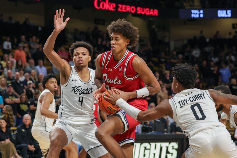 Nov 12, 2024; Orlando, Florida, USA; Florida Atlantic Owls forward Baba Miller (18) drives to the basket against UCF Knights guard Jordan Ivy-Curry (0) during the first half at Addition Financial Arena. Mandatory Credit: Mike Watters-Imagn Images