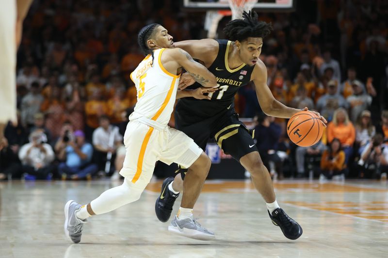 Feb 15, 2025; Knoxville, Tennessee, USA; Vanderbilt Commodores guard AJ Hoggard (11) moves the ball against Tennessee Volunteers guard Zakai Zeigler (5) during the first half at Thompson-Boling Arena at Food City Center. Mandatory Credit: Randy Sartin-Imagn Images