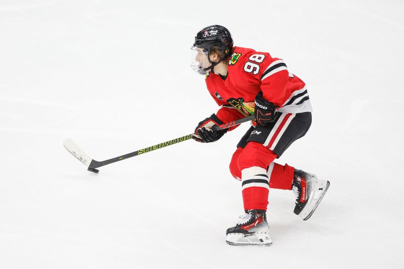 Mar 26, 2024; Chicago, Illinois, USA; Chicago Blackhawks center Connor Bedard (98) looks to shoot against the Calgary Flames during the first period at United Center. Mandatory Credit: Kamil Krzaczynski-USA TODAY Sports