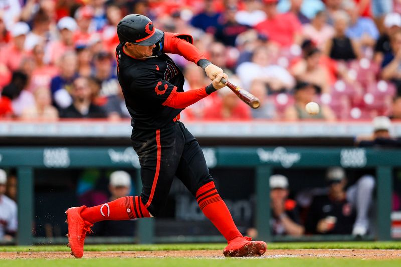 May 16, 2025; Cincinnati, Ohio, USA; Cincinnati Reds outfielder Austin Hays (12) hits a single in the seventh inning against the Cleveland Guardians at Great American Ball Park. Mandatory Credit: Katie Stratman-Imagn Images