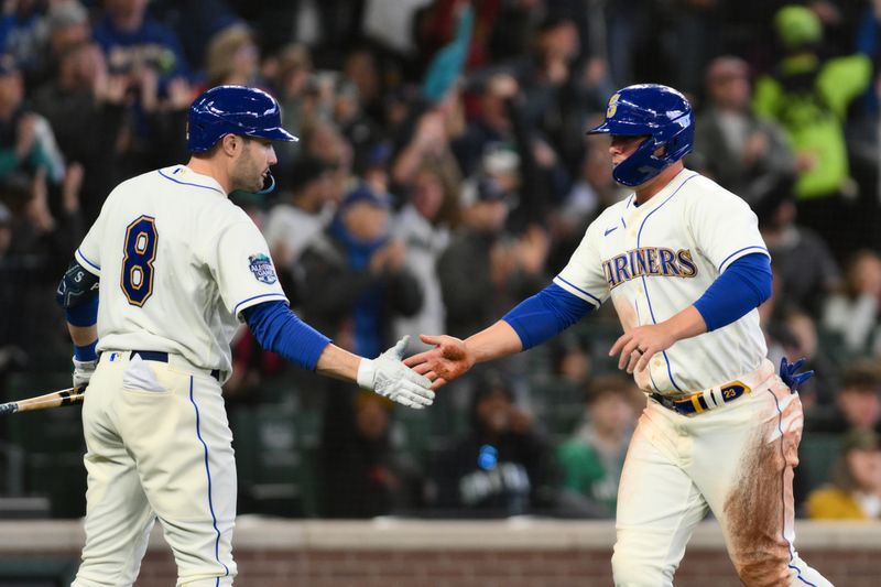 Apr 16, 2023; Seattle, Washington, USA; Seattle Mariners left fielder AJ Pollock (8) and first baseman Ty France (23) celebrate after France scored a run against the Colorado Rockies during the sixth inning at T-Mobile Park. Mandatory Credit: Steven Bisig-USA TODAY Sports