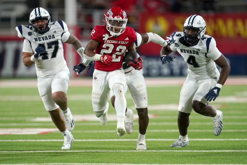 Sep 30, 2023; Fresno, California, USA; Fresno State Bulldogs running back Malik Sherrod (22) runs past Nevada Wolf Pack defensive lineman Hunter Kaupiko (47), linebacker Drue Watts (32), and inebacker Lli'jah Winston (4) in the fourth quarter at Valley Children's Stadium. Mandatory Credit: Cary Edmondson-USA TODAY Sports