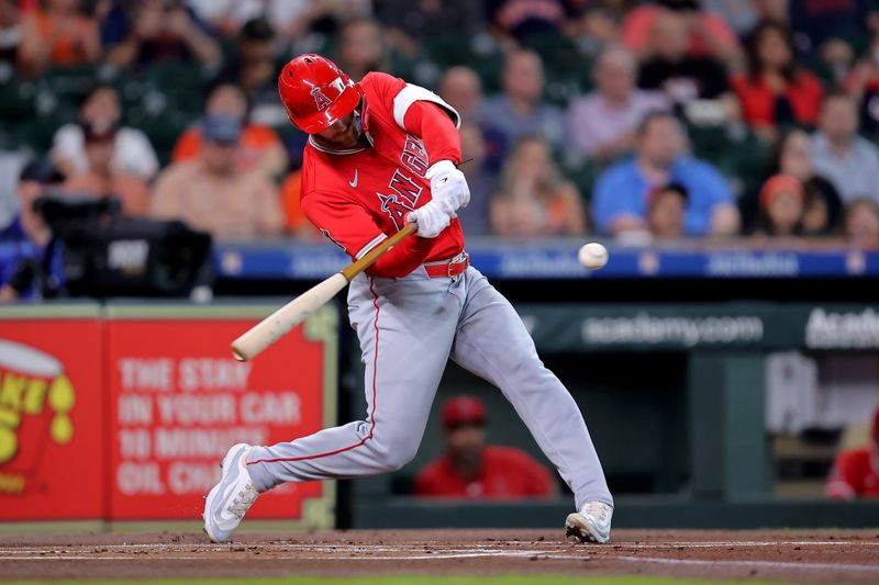 May 20, 2024; Houston, Texas, USA; Los Angeles Angels left fielder Taylor Ward (3) hits a RBI sacrifice fly against the Houston Astros during the first inning at Minute Maid Park. Mandatory Credit: Erik Williams-USA TODAY Sports