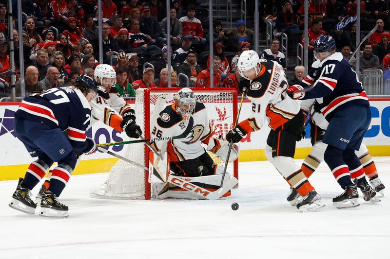 Jan 16, 2024; Washington, District of Columbia, USA; Anaheim Ducks goaltender John Gibson (36) makes a save on Washington Capitals right wing T.J. Oshie (77) as Ducks center Isac Lundestrom (21) defends in the first period at Capital One Arena. Mandatory Credit: Geoff Burke-USA TODAY Sports