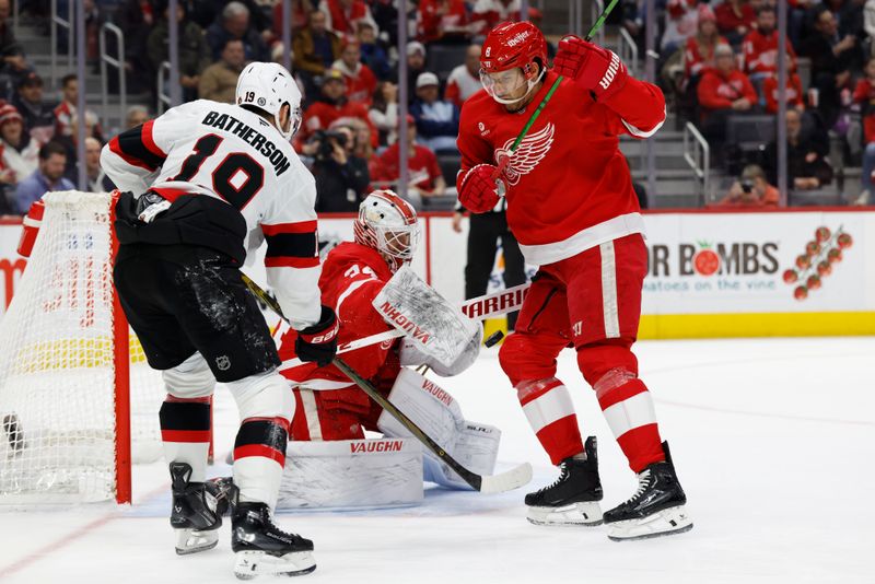 Jan 7, 2025; Detroit, Michigan, USA; Detroit Red Wings goaltender Alex Lyon (34) makes a save on Ottawa Senators right wing Drake Batherson (19) in front of defenseman Ben Chiarot (8) in the first period at Little Caesars Arena. Mandatory Credit: Rick Osentoski-Imagn Images