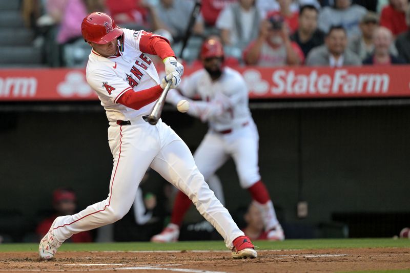May 30, 2024; Anaheim, California, USA;  Los Angeles Angels catcher Logan O'Hoppe (14) hits a solo home run in the first inning against the New York Yankees at Angel Stadium. Mandatory Credit: Jayne Kamin-Oncea-USA TODAY Sports