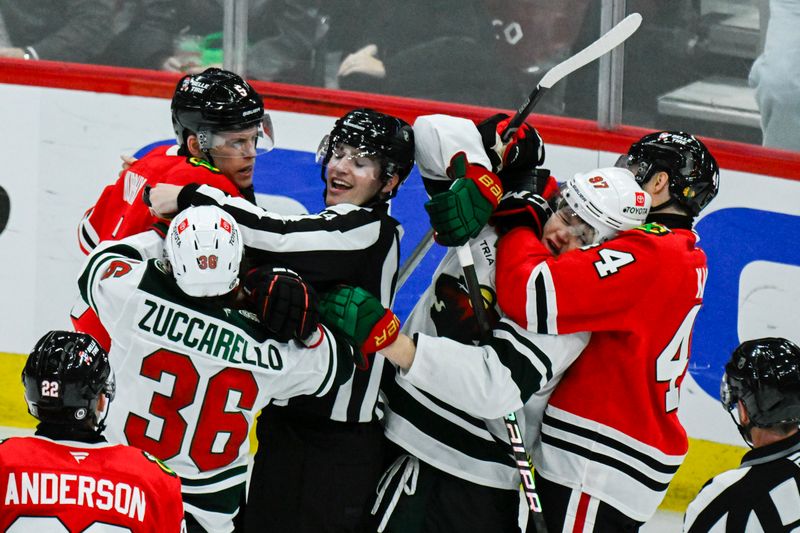 Nov 10, 2024; Chicago, Illinois, USA;  Chicago Blackhawks defenseman Wyatt Kaiser (44) holds Minnesota Wild left wing Kirill Kaprizov (97) as other players tussle during the third  period at the United Center. Mandatory Credit: Matt Marton-Imagn Images