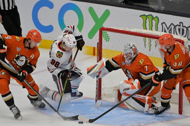 Nov 3, 2024; Anaheim, California, USA;  Anaheim Ducks center Trevor Zegras (11), Chicago Blackhawks center Connor Bedard (98), Anaheim Ducks goaltender Lukas Dostal (1) and defenseman Pavel Mintyukov (34) battle for the puck in the second period at Honda Center. Mandatory Credit: Jayne Kamin-Oncea-Imagn Images