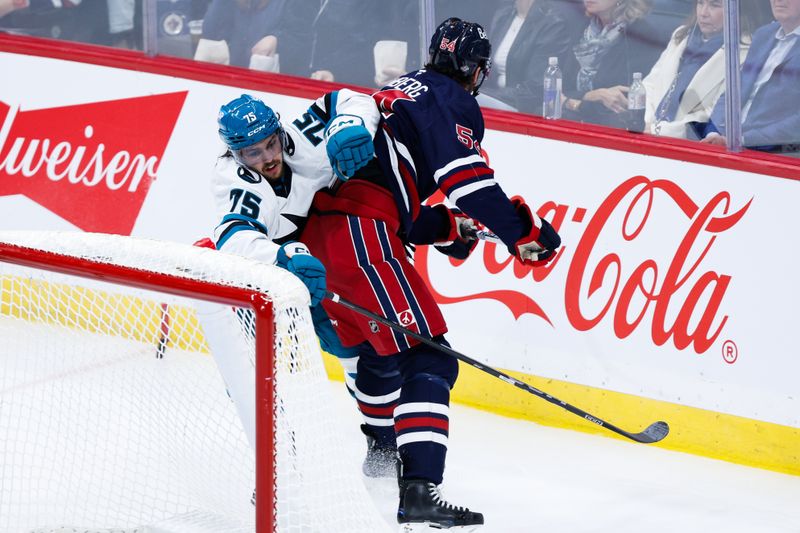 Oct 18, 2024; Winnipeg, Manitoba, CAN;  Winnipeg Jets defenseman Dylan Samberg (54) checks San Jose Sharks forward Danil Gushchin (75) during the third period at Canada Life Centre. Mandatory Credit: Terrence Lee-Imagn Images