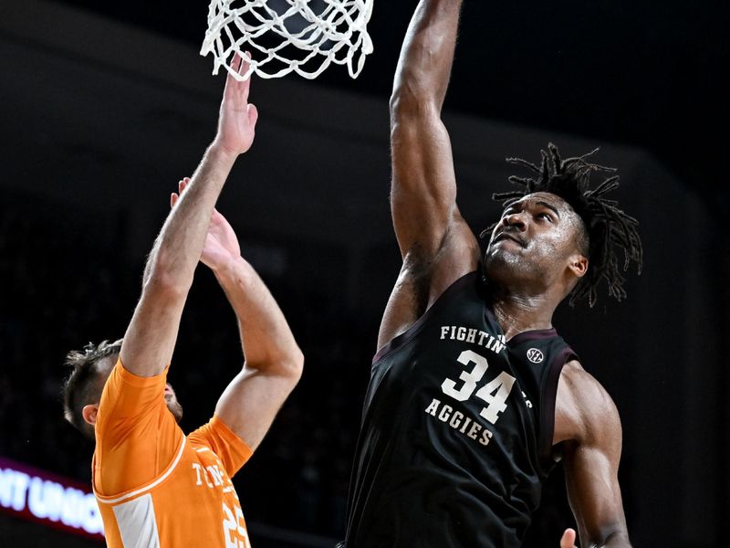 Feb 21, 2023; College Station, Texas, USA;  Texas A&M Aggies forward Julius Marble (34) drives to the basket against Tennessee Volunteers guard Santiago Vescovi (25) during the second half at Reed Arena. Mandatory Credit: Maria Lysaker-USA TODAY Sports