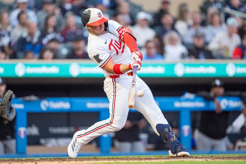 Apr 23, 2025; Minneapolis, Minnesota, USA; Minnesota Twins first base Ty France (13) singles off Chicago White Sox starting pitcher Bryse Wilson (46) and scoring Minnesota Twins second base Luke Keaschall (15) in the third inning at Target Field. Mandatory Credit: Matt Blewett-Imagn Images