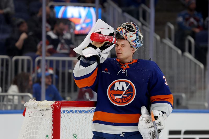 Jan 28, 2025; Elmont, New York, USA; New York Islanders goaltender Ilya Sorokin (30) sprays water on his face during the third period against the Colorado Avalanche at UBS Arena. Mandatory Credit: Brad Penner-Imagn Images