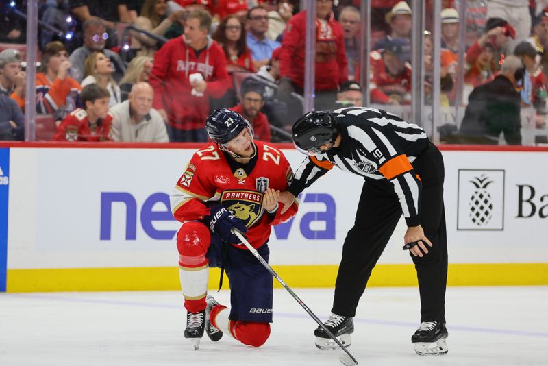 Jun 24, 2024; Sunrise, Florida, USA; Florida Panthers forward Eetu Luostarinen (27) is looked at by the referee during the third period against the Edmonton Oilers in game seven of the 2024 Stanley Cup Final at Amerant Bank Arena. Mandatory Credit: Sam Navarro-USA TODAY Sports