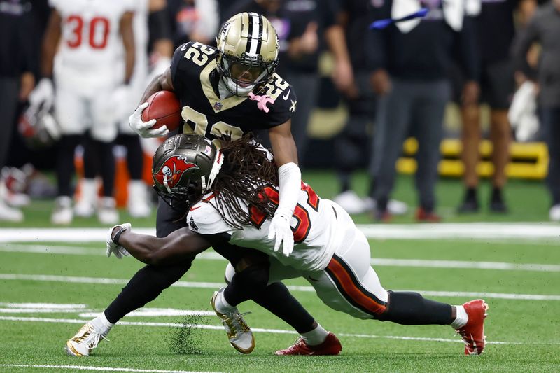 New Orleans Saints' Rashid Shaheed (22) runs against Tampa Bay Buccaneers' Tavierre Thomas during the second half of an NFL football game in New Orleans, Sunday, Oct. 13, 2024. (AP Photo/Butch Dill)