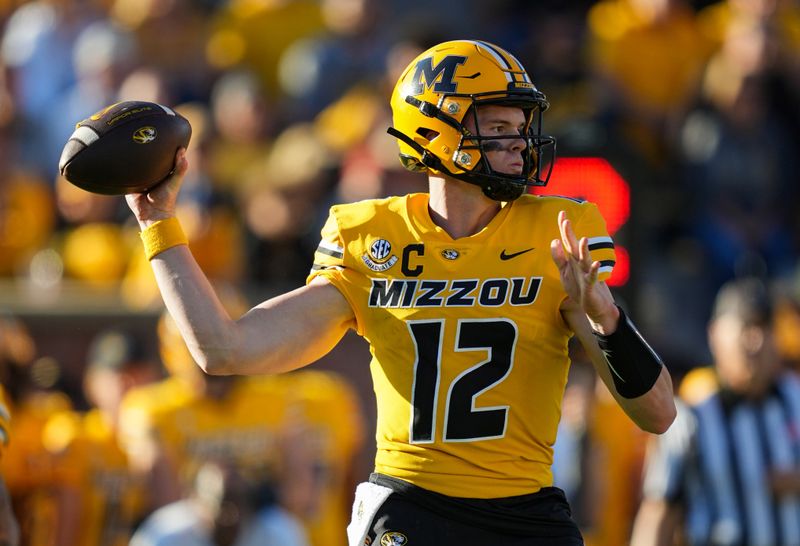 Oct 21, 2023; Columbia, Missouri, USA; Missouri Tigers quarterback Brady Cook (12) throws a pass during the second half against the South Carolina Gamecocks at Faurot Field at Memorial Stadium. Mandatory Credit: Jay Biggerstaff-USA TODAY Sports