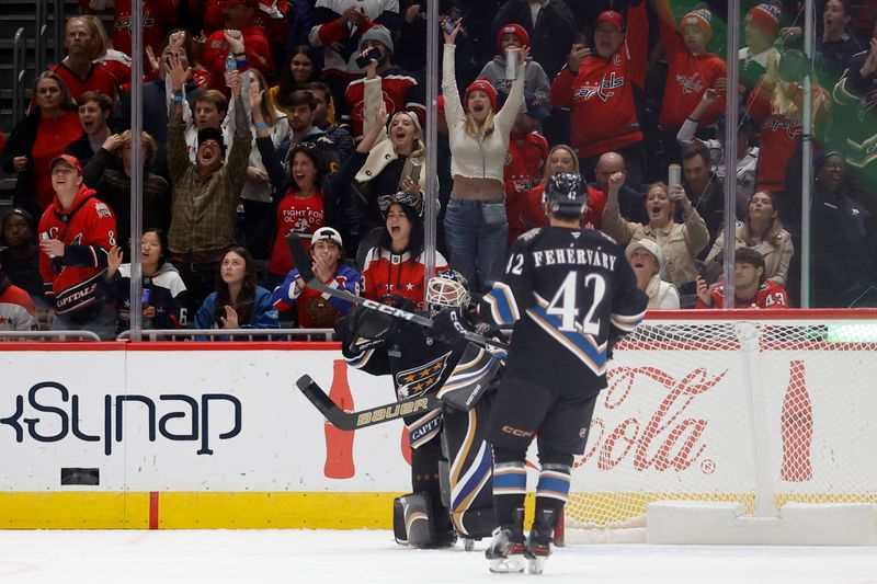 Nov 6, 2024; Washington, District of Columbia, USA; Washington Capitals goaltender Logan Thompson (48) celebrates with Capitals defenseman Martin Fehervary (42) after the final horn against the Nashville Predators at Capital One Arena. Mandatory Credit: Geoff Burke-Imagn Images