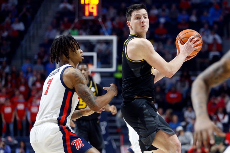 Feb 17, 2024; Oxford, Mississippi, USA; Missouri Tigers forward Jesus Carralero Martin (13) handles the ball as Mississippi Rebels guard Allen Flanigan (7) defends during the first half at The Sandy and John Black Pavilion at Ole Miss. Mandatory Credit: Petre Thomas-USA TODAY Sports