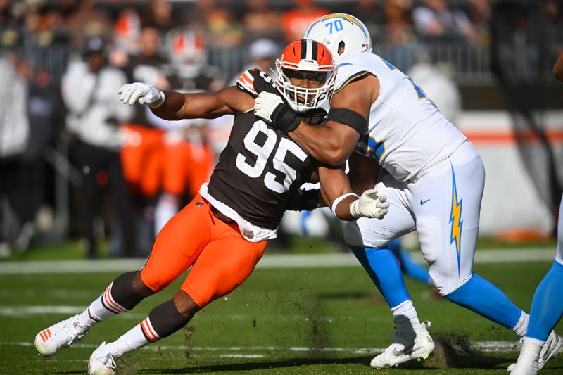 Cleveland Browns defensive end Myles Garrett (95) rushes against Los Angeles Chargers offensive tackle Rashawn Slater (70) in the first half of an NFL football game Sunday, Nov. 3, 2024, in Cleveland. (AP Photo/David Richard)