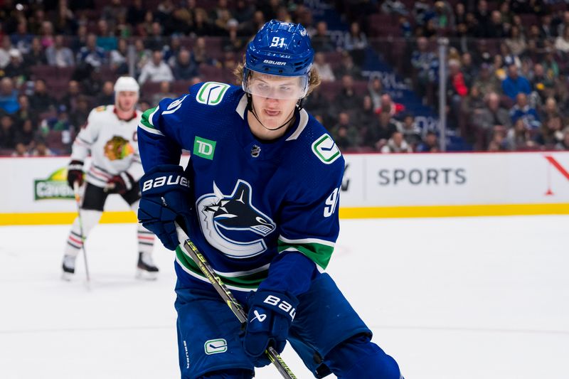 Apr 6, 2023; Vancouver, British Columbia, CAN; Vancouver Canucks forward Vitali Kravtsov (91) looks for the loose puck against the Chicago Blackhawks in the second period at Rogers Arena. Mandatory Credit: Bob Frid-USA TODAY Sports